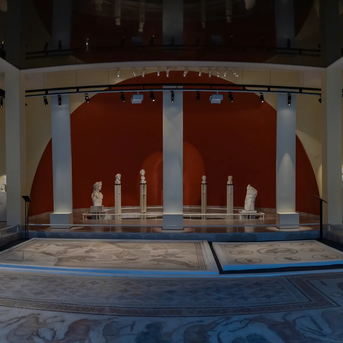 Roman mosaics displayed in a vaulted museum hall